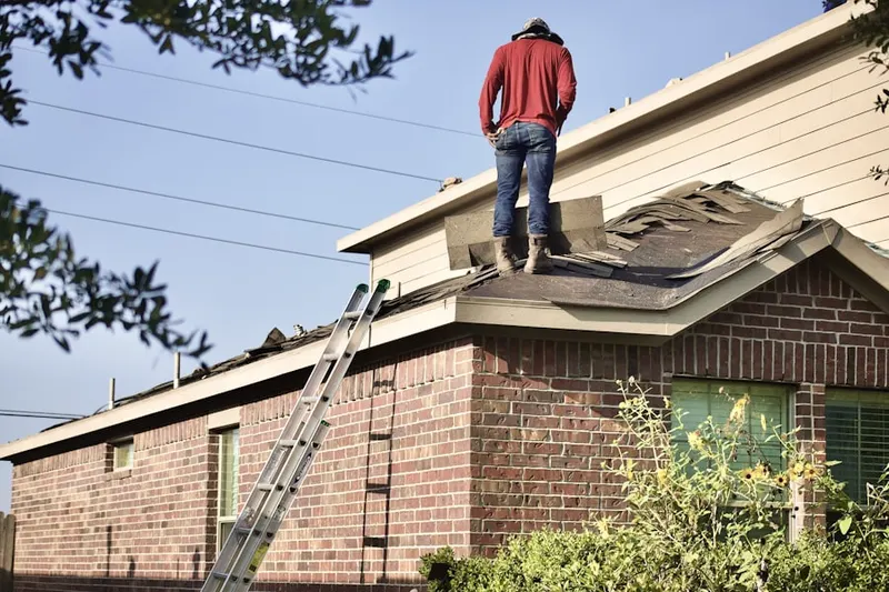 Professional roofer working on a residential roof in Baltusrol